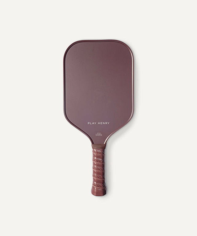 Play Henry carbon fiber pickleball paddle with maroon surface and textured grip handle
