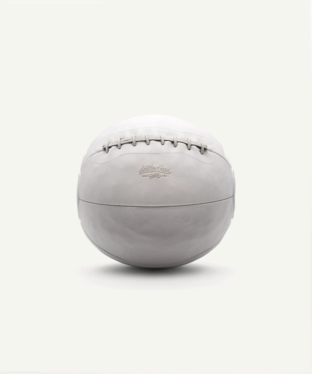 Leather Head Sports 14 lb white medicine ball with stitched leather design for strength training