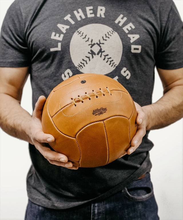 Leather Head Sports 1930 World Cup replica soccer ball held by person in gray shirt