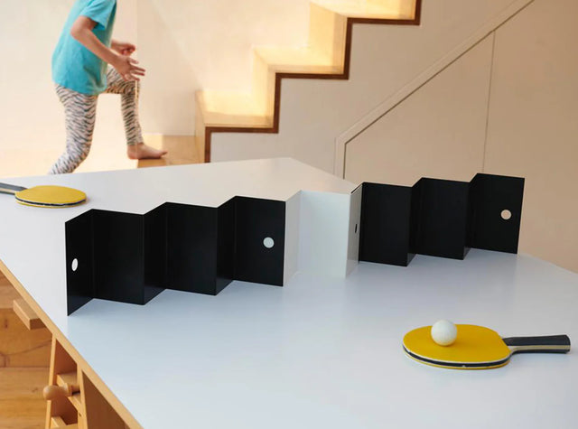 Aesthetic ping pong table tennis set with black folding net and yellow paddles on white table