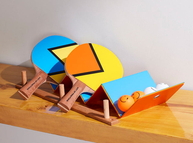 Art of Ping Pong aesthetic ping pong table tennis paddles and balls set on wooden rack