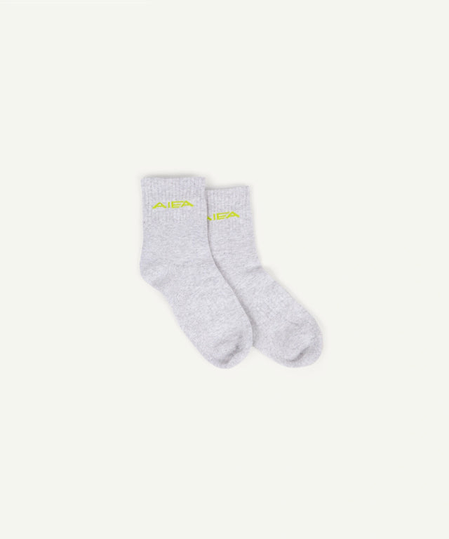 AIEA Golf light gray socks with neon yellow logo, part of fashionable womens golf clothing collection