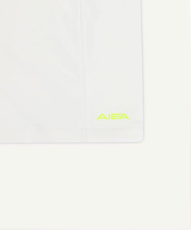Close-up of white AIEA Golf apparel featuring logo detail for fashionable womens golf clothing