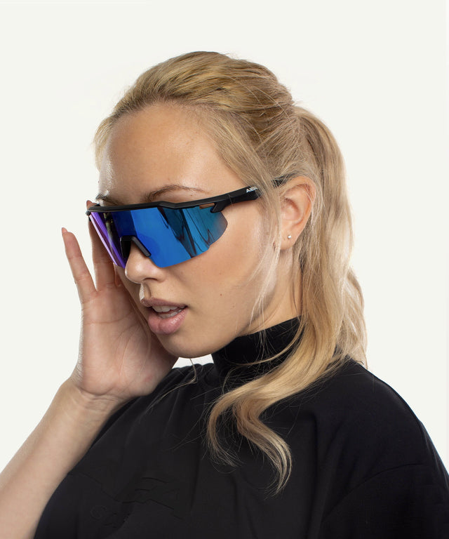AIEA Golf fashionable womens golf sunglasses with blue mirrored lenses worn by a blonde woman