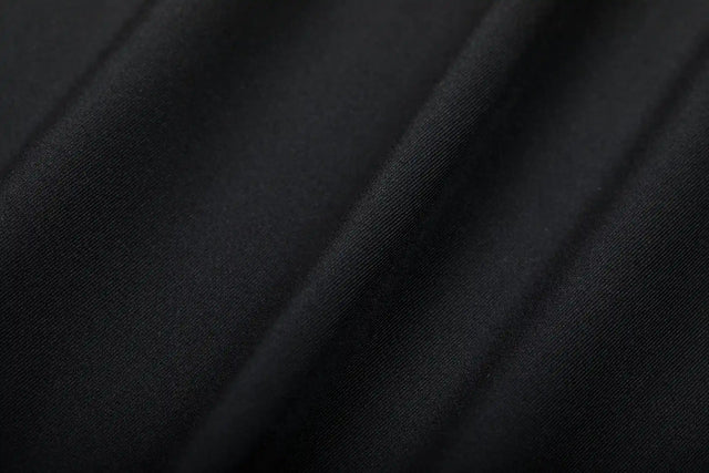 Close-up of black fabric texture showcasing Solstice Athletics premium workout clothing material