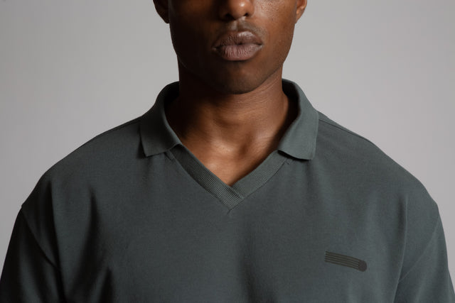 Kadet men's performance polo shirt in dark gray with V-neck collar and subtle logo on chest