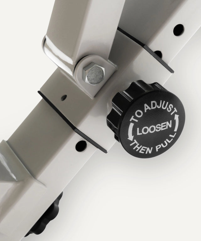 Close-up of adjustment knob on WeGym adjustable fitness bench showing tighten and loosen instructions