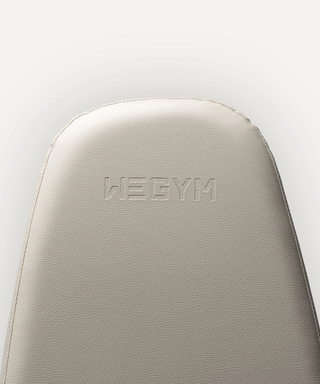 Close-up of WeGym adjustable fitness bench padded backrest in light gray color
