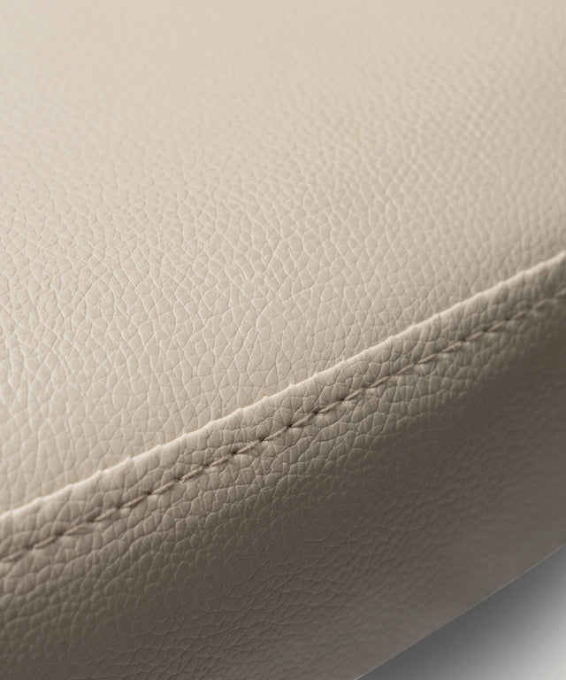 Close-up of beige leather cushion detail on WeGym adjustable fitness bench with fine stitching