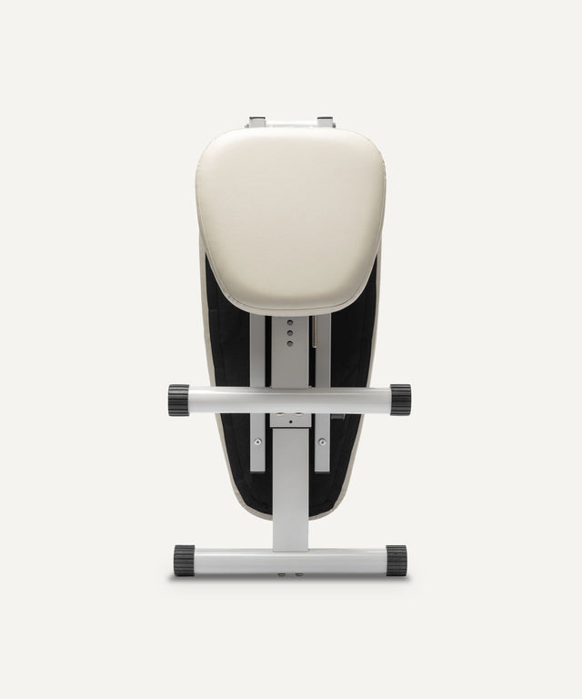 WeGym adjustable fitness bench with padded cream seat and sturdy metal frame for versatile workouts