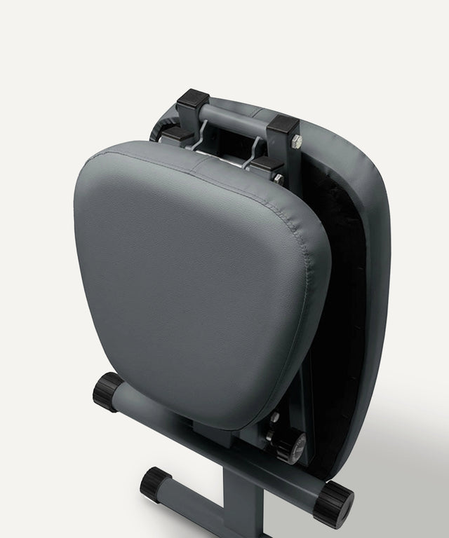 WeGym adjustable fitness bench folded with padded gray seat and durable frame