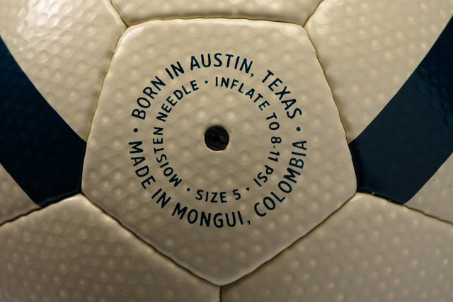 Close-up of the valve area on a Hayworth Athletic standard model soccer ball with inflation instructions
