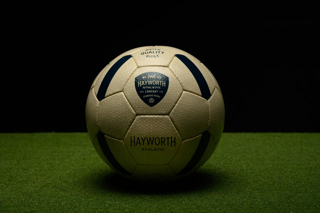 Hayworth Athletic standard model soccer ball on green turf with black and white panels