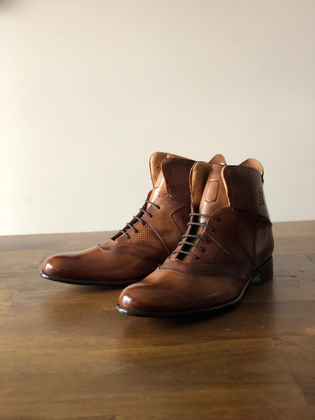 The Rafter Club Italian made mens dress shoe in brown leather with lace-up design on wooden surface