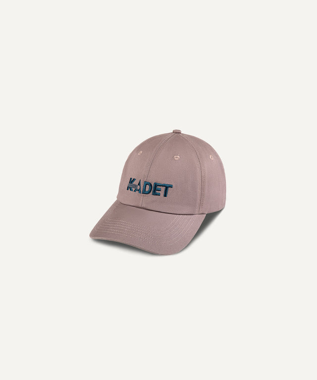 Kadet logo cotton twill hat in muted brown with embroidered dark blue Kadet logo on front