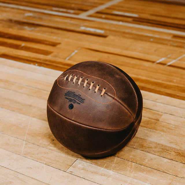 Leather Head Sports vintage style brown leather Naismith basketball for sale on wooden court