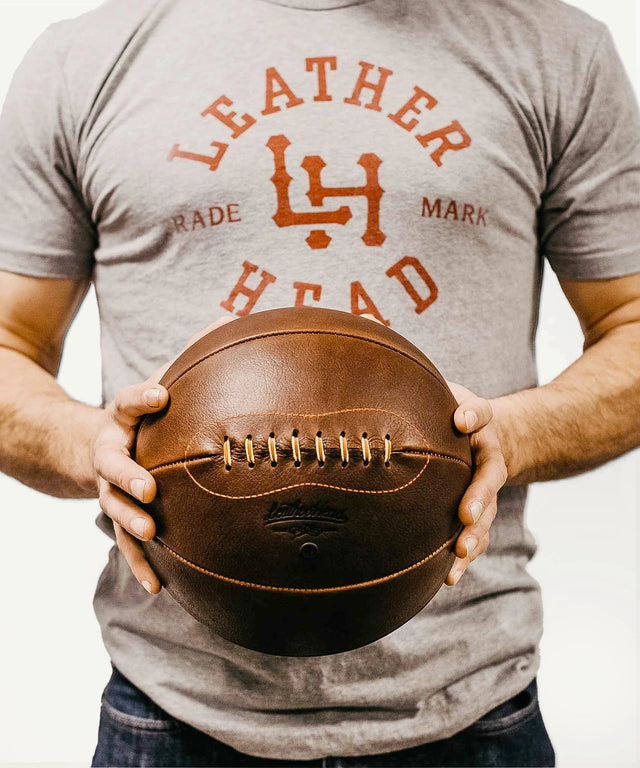 Leather Head Sports Naismith basketball for sale held by person wearing a Leather Head t-shirt