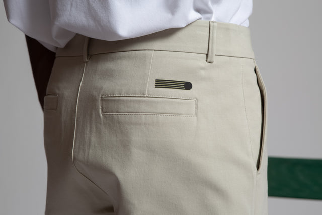 Close-up of Kadet men's chino shorts in beige showing back pocket and belt loops