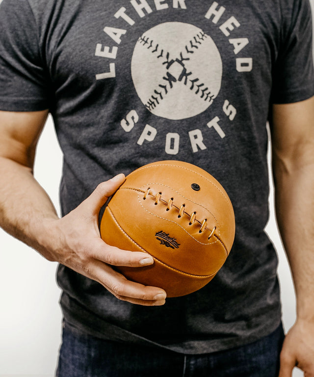 Leather Head Sports onyx mini basketball in brown leather held by person wearing dark t-shirt