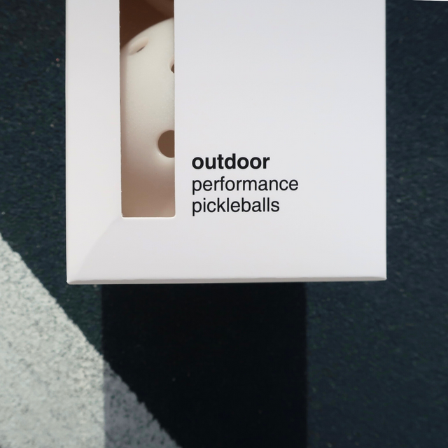 Play Henry white outdoor pickleball balls in white packaging with outdoor performance label