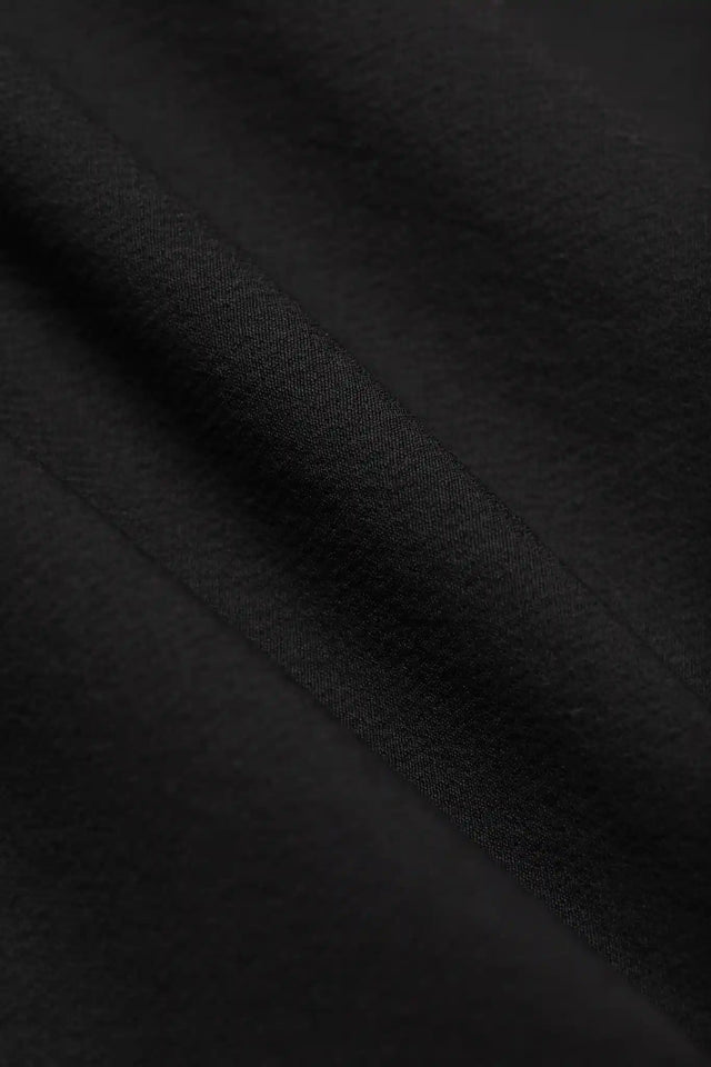 Close-up of black fabric texture from Solstice Athletics premium workout clothing