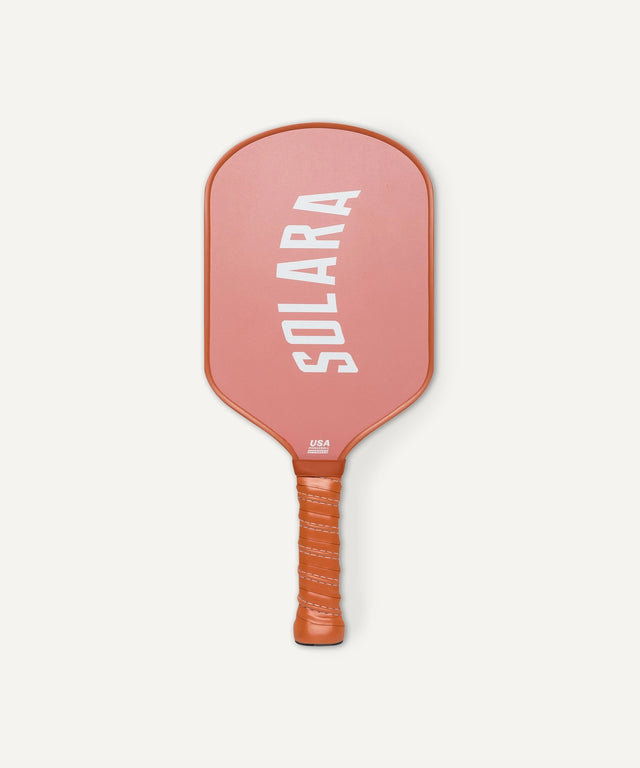 Solara 94 branded lightweight coral pickleball paddle with textured grip handle