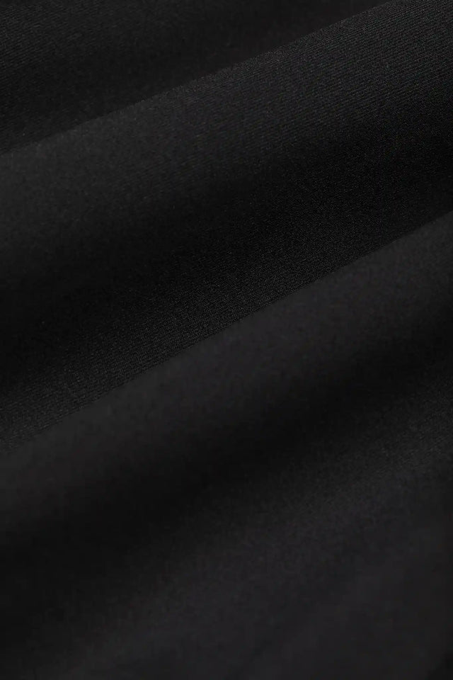 Close-up of black fabric texture for premium workout clothing by Solstice Athletics