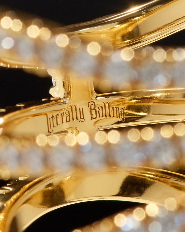 Close-up of Literally Balling gold basketball jewelry featuring Victor Solomon engraving for gifts for basketball fans