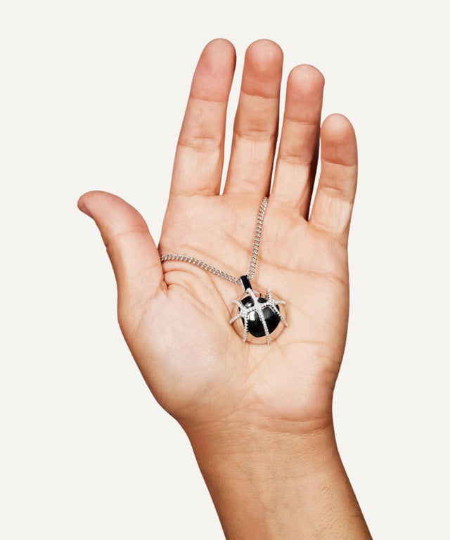 Victor Solomon basketball jewelry pendant held in hand by Literally Balling, perfect gifts for basketball fans