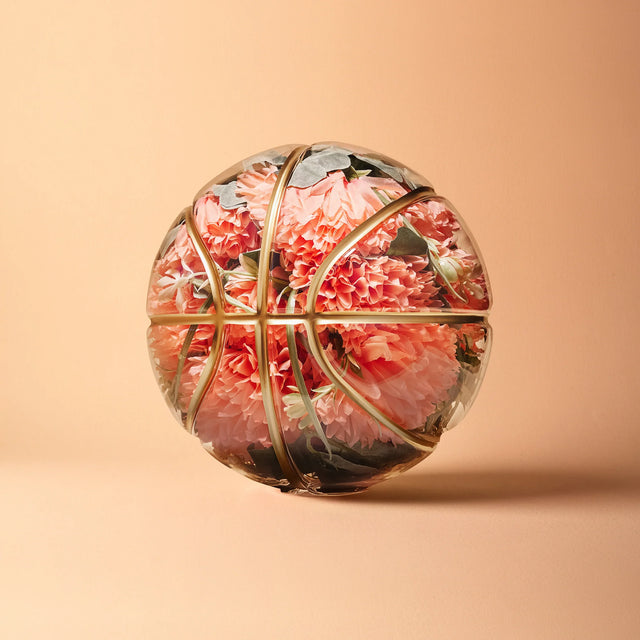 Basketball-shaped art piece with pink flowers encapsulated by Victor Solomon NBA collectibles gifts for basketball fans