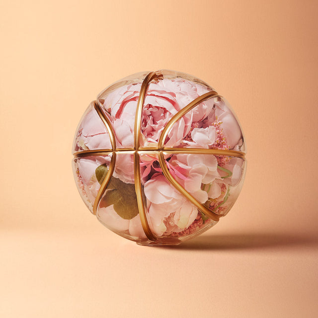Literally Balling vessel shaped like a basketball filled with pink flowers by Victor Solomon art collectibles gifts for basketball fans