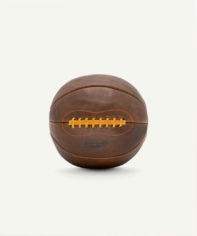 Leather Head Sports vintage leather medicine ball with stitched laces and textured surface for strength training